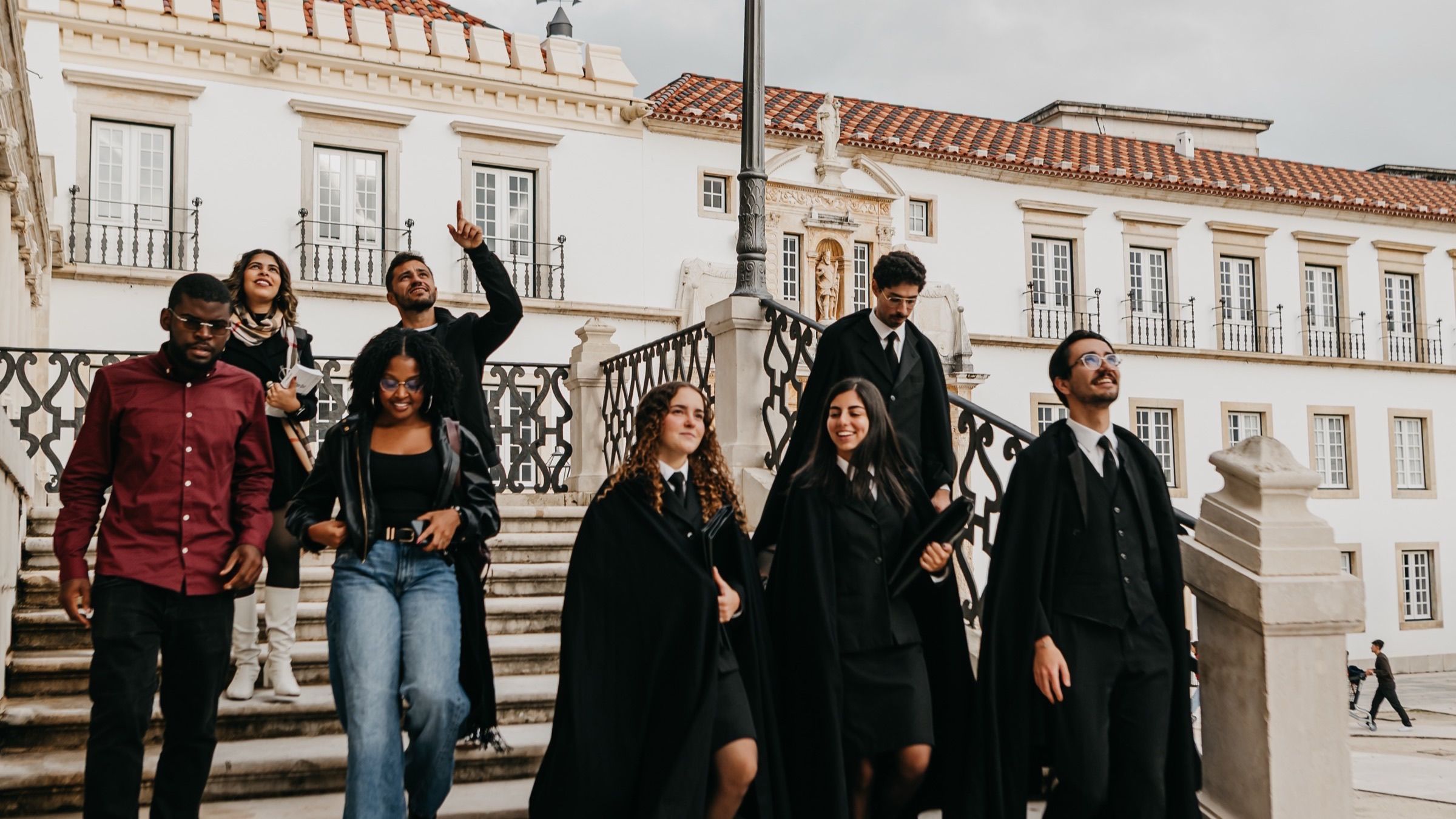 Students in academic capes gathered on the university steps.