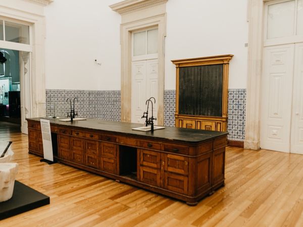 The Chemistry Laboratory, its original wooden workbench standing in a tall white room.