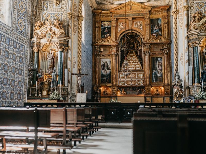 The interior of St Michael’s Chapel, looking down the tiled nave to the gilded altarpiece.