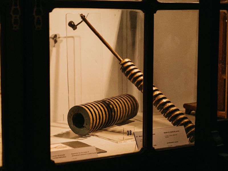 A brass and wood demonstration instrument from the Physics Cabinet, seen in close-up.