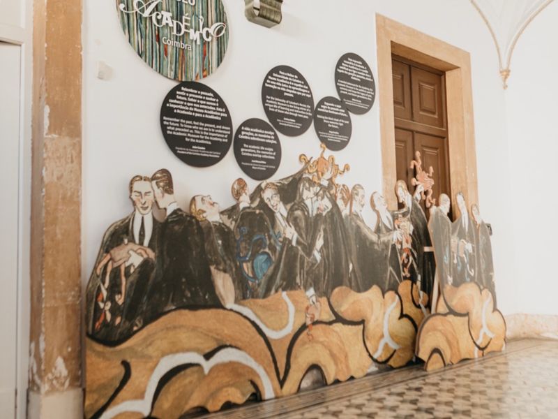 Cut-out figures of caped students mounted along a wall of the Academic Museum.