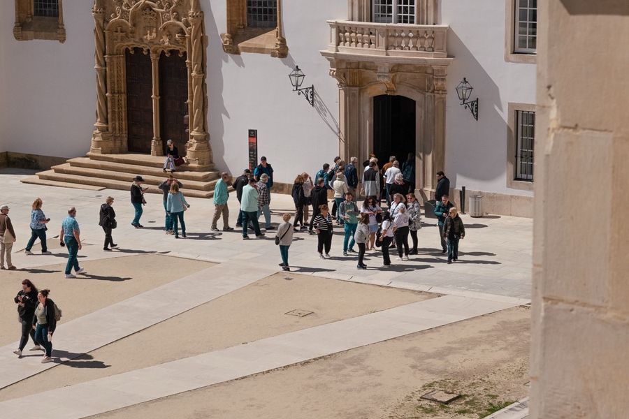 Visitors crossing the arcaded courtyard outside St Michael’s Chapel.