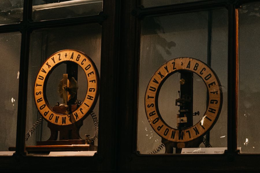 Two gilded instruments displayed side by side in a glass case.