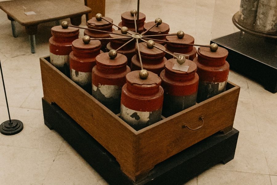 A set of red-topped apparatus arranged on a wooden base.