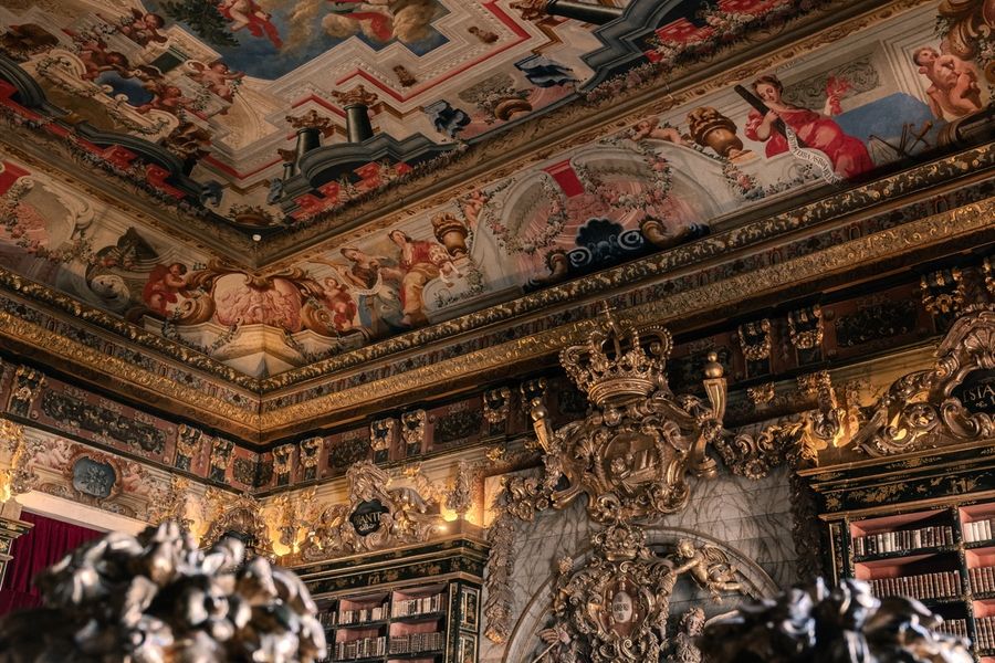 A gilded doorway inside the Joanina Library, carved and painted in green and gold.