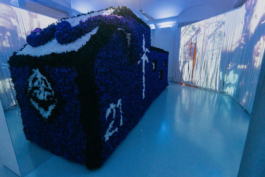 A blue-lit installation of student memorabilia at the Academic Museum.