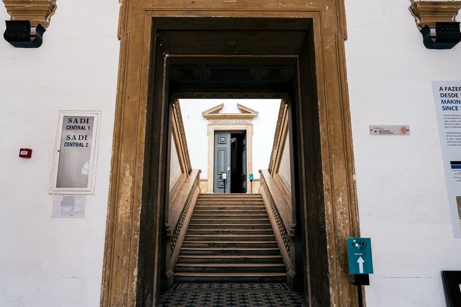 A long corridor of the Science Museum, patterned floor running towards a lit doorway.