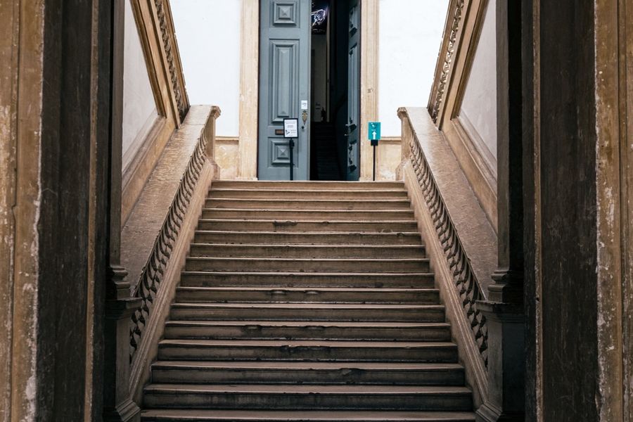 A stone staircase inside the Science Museum, framed by a high arched opening.