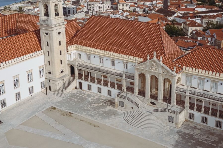 The tower seen from above the tiled rooftops of the university quarter.